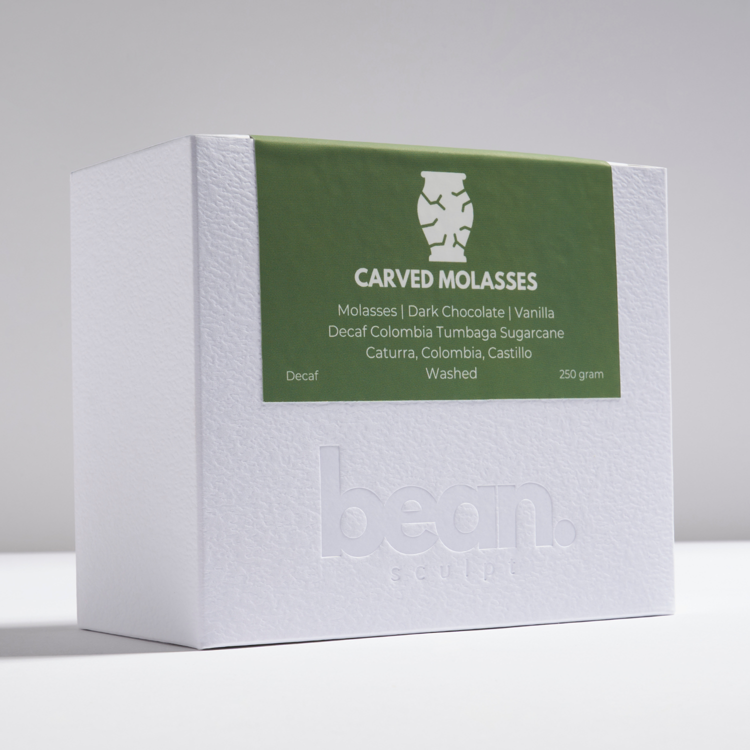 Front view of Bean Sculpt’s signature white box featuring Carved Molasses Decaf Coffee. A Single Origin Coffee, ideal for Filter or Espresso brewing. 