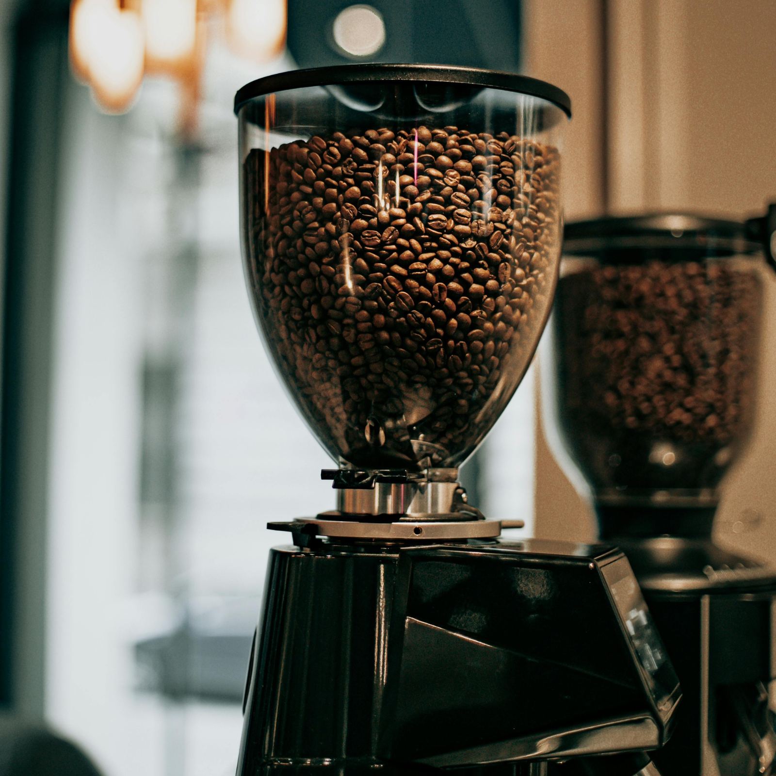 Espresso coffee grinders filled with freshly roasted coffee, ready for precise espresso brewing.